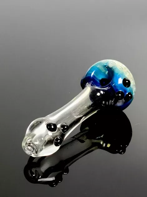 Clear glass spoon with blue bubble bowl and black marbles