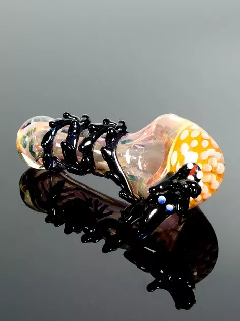 Pink glass spoon with black dragon with blown in puffs